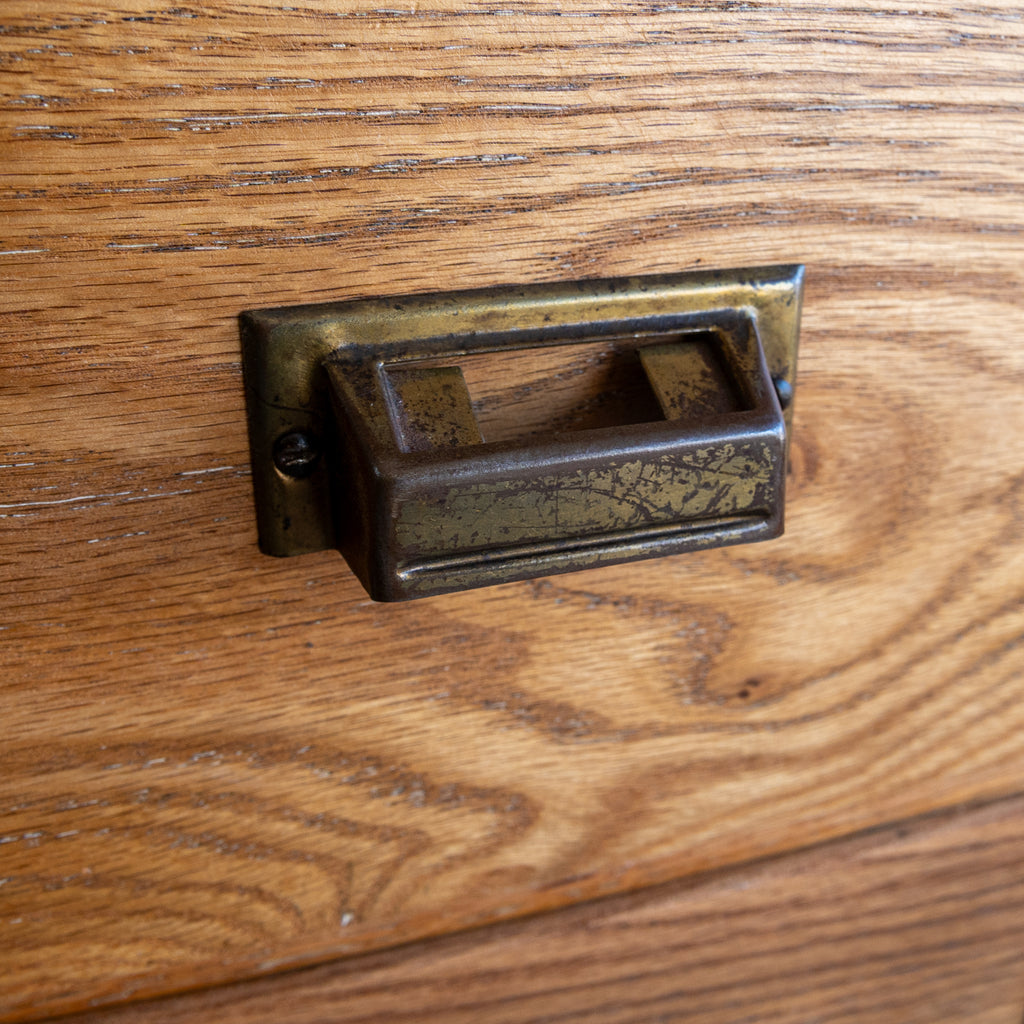 reclaimed apothecary cabinet oak brass pull close up view