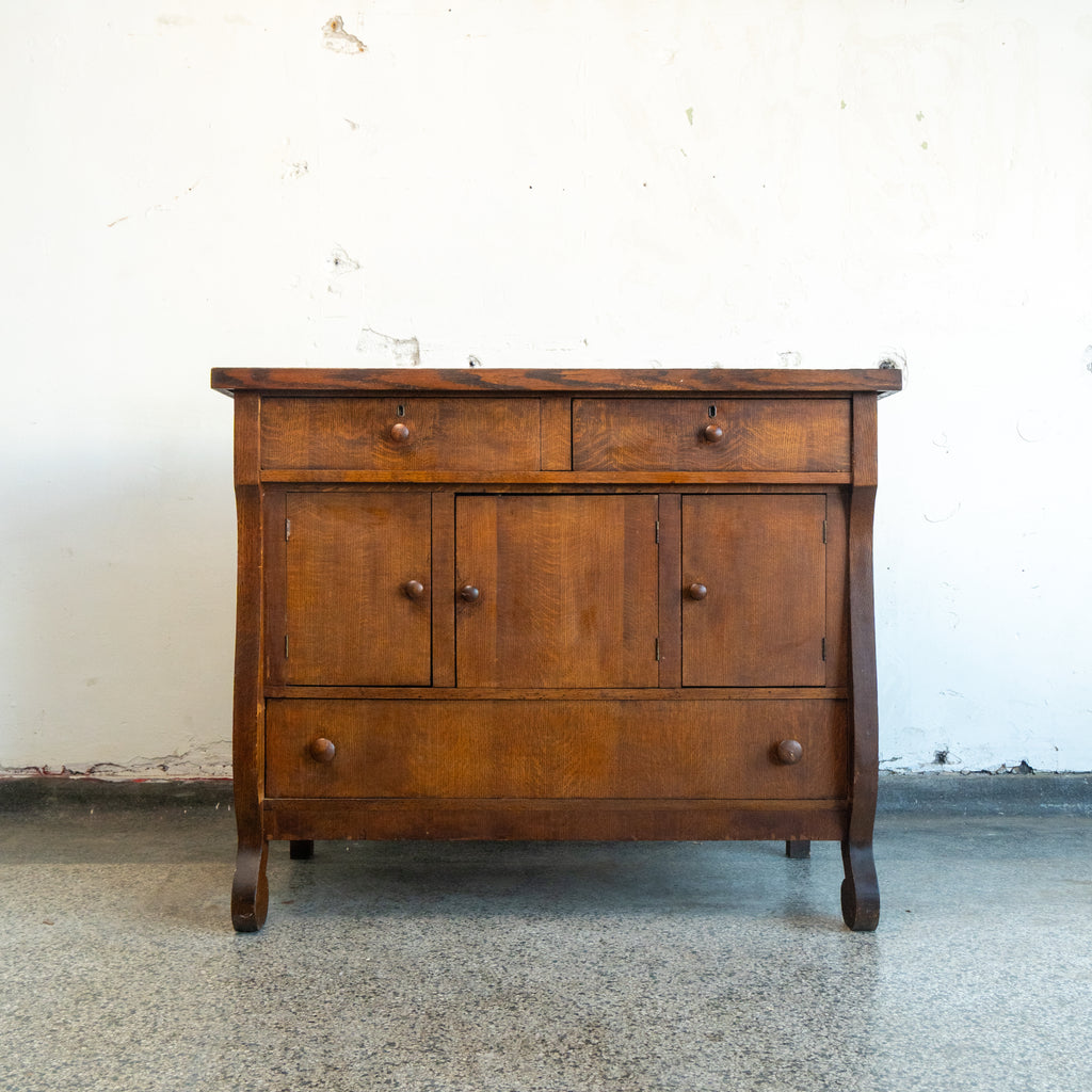 Wooden dresser with two drawers and three doors on a white background front view
