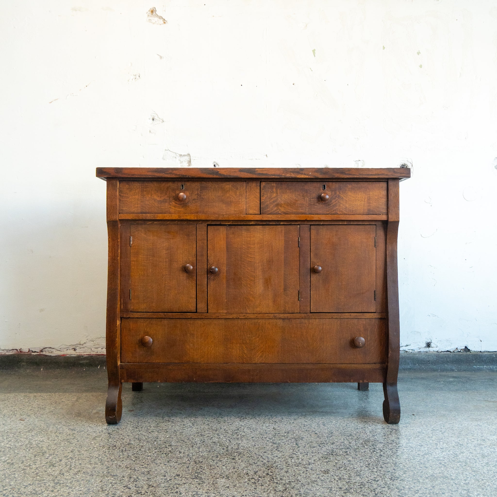 Wooden dresser with two drawers and three doors on a white background front view