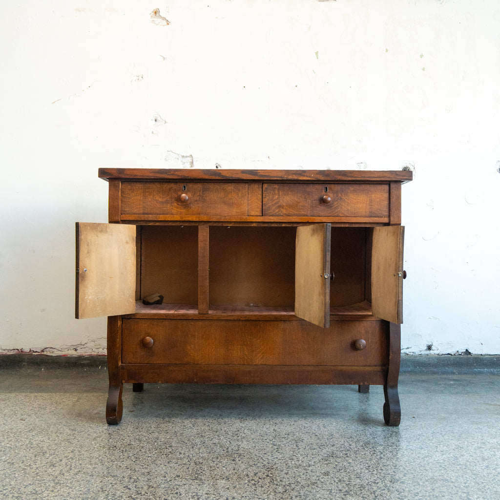 Wooden sideboard with open doors on a white background