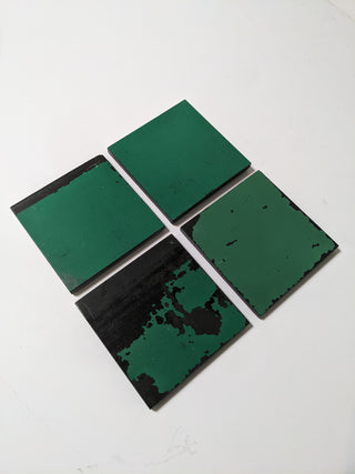 4 Schoolhouse Chalkboard Coasters in distressed green and slate. Angled view.
