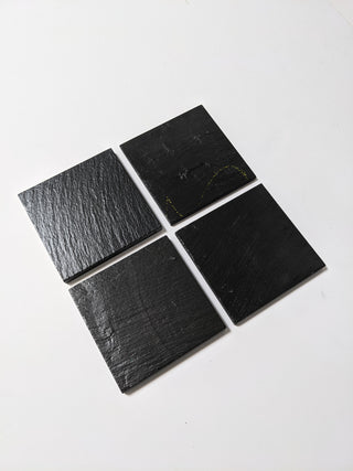 4 Schoolhouse Chalkboard Coasters in dark slate. Angled view.