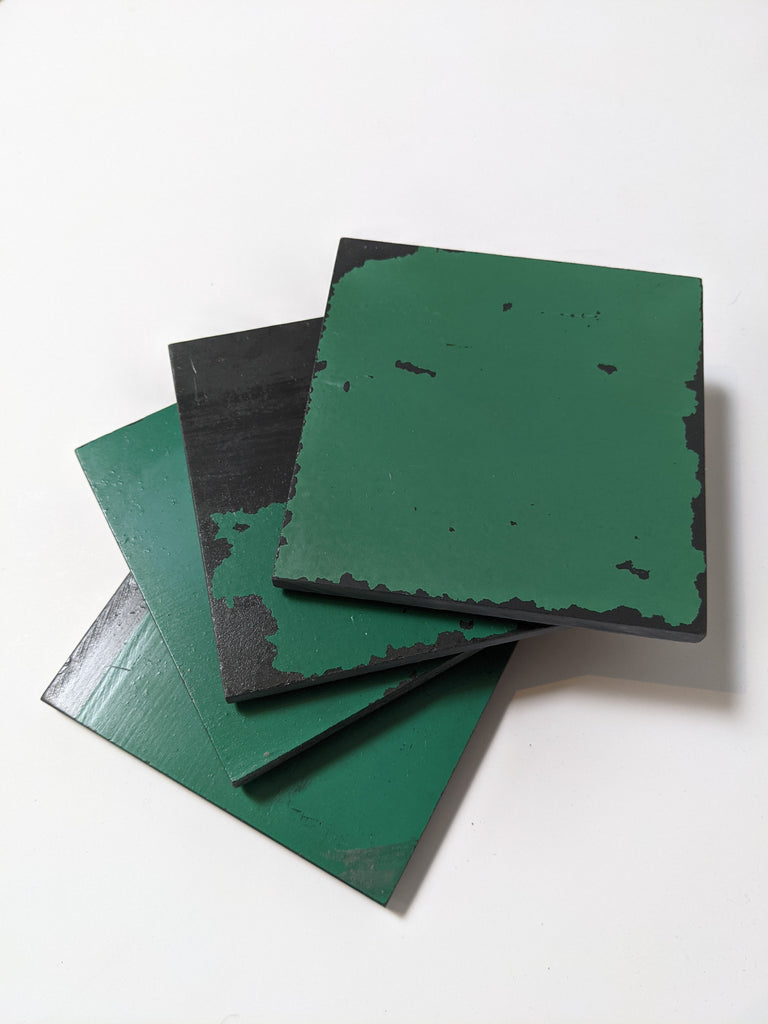 4 Schoolhouse Chalkboard Coasters in distressed green and slate. Stacked view.